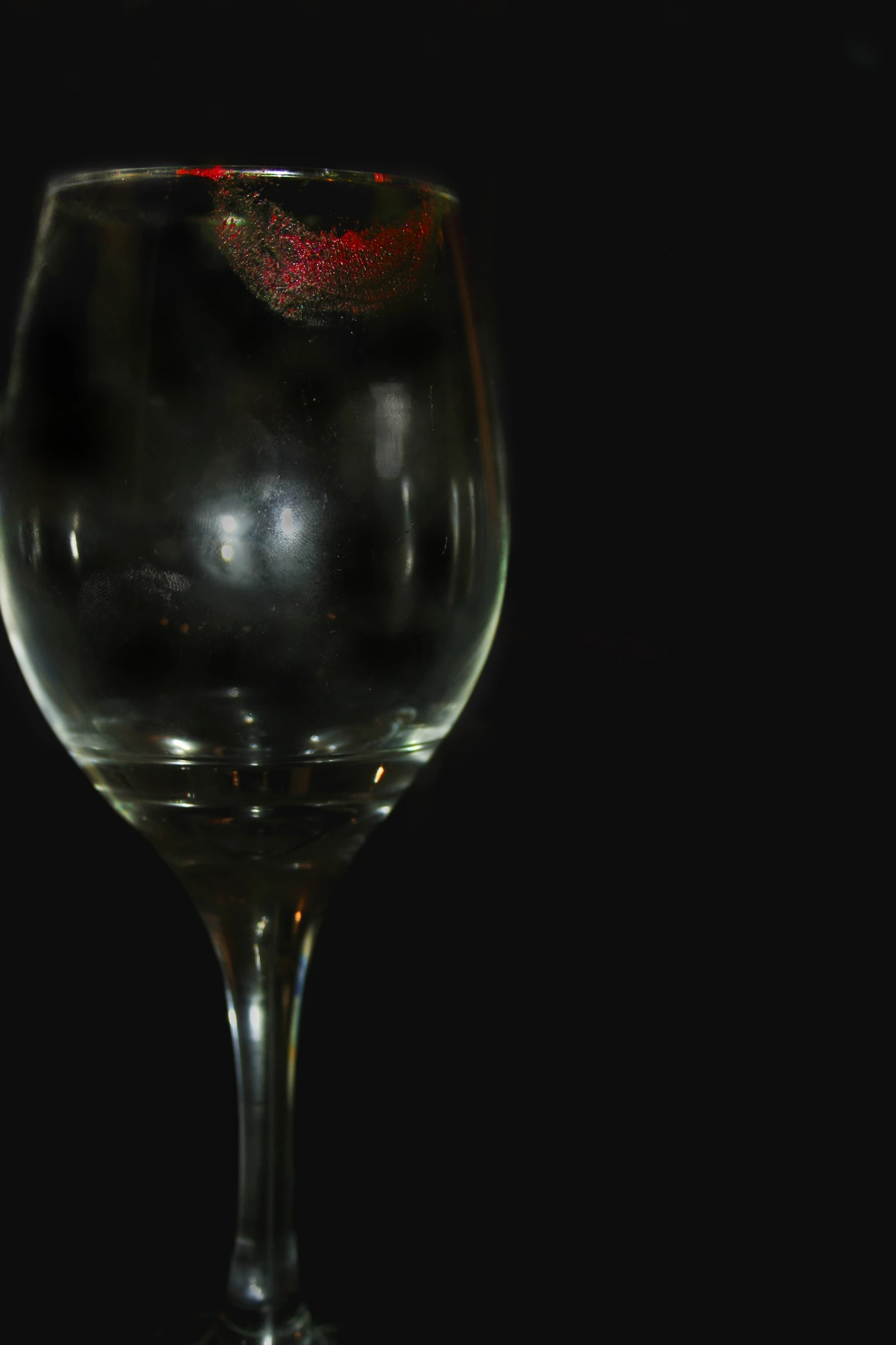 a glass with some black and red liquid
