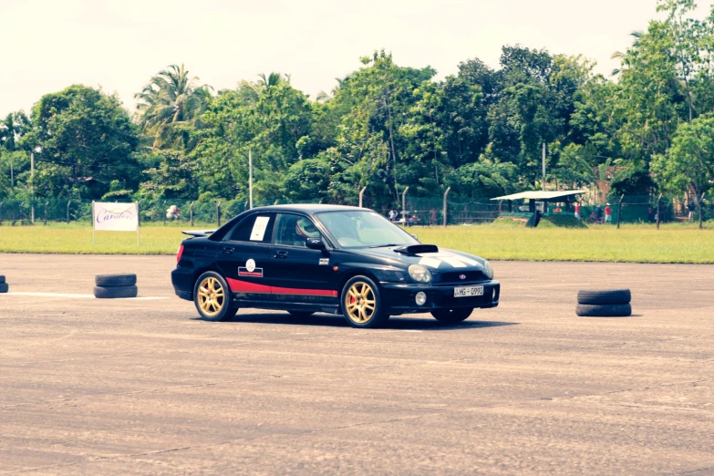 a smart car is shown in the middle of an asphalt lot