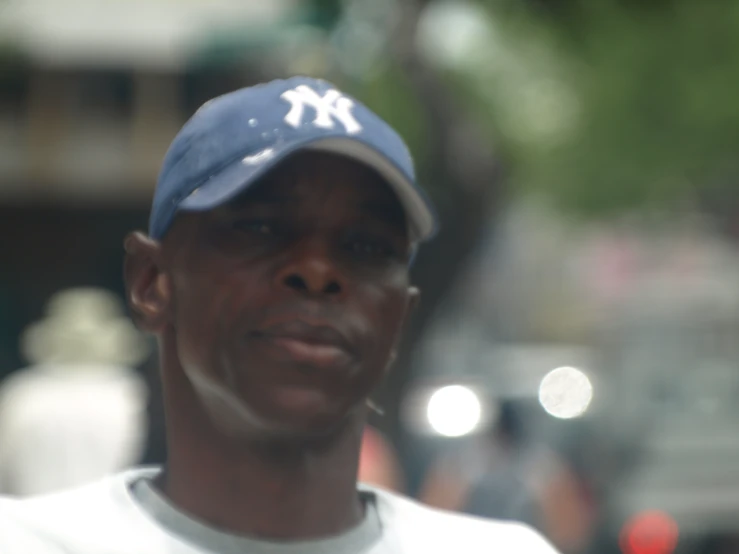 an african american man wearing a hat and talking on the phone