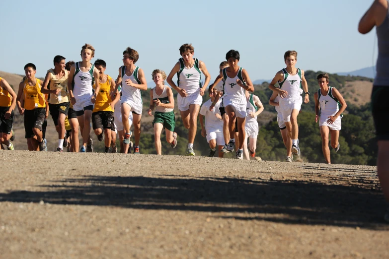 group of young men racing a long run in a race