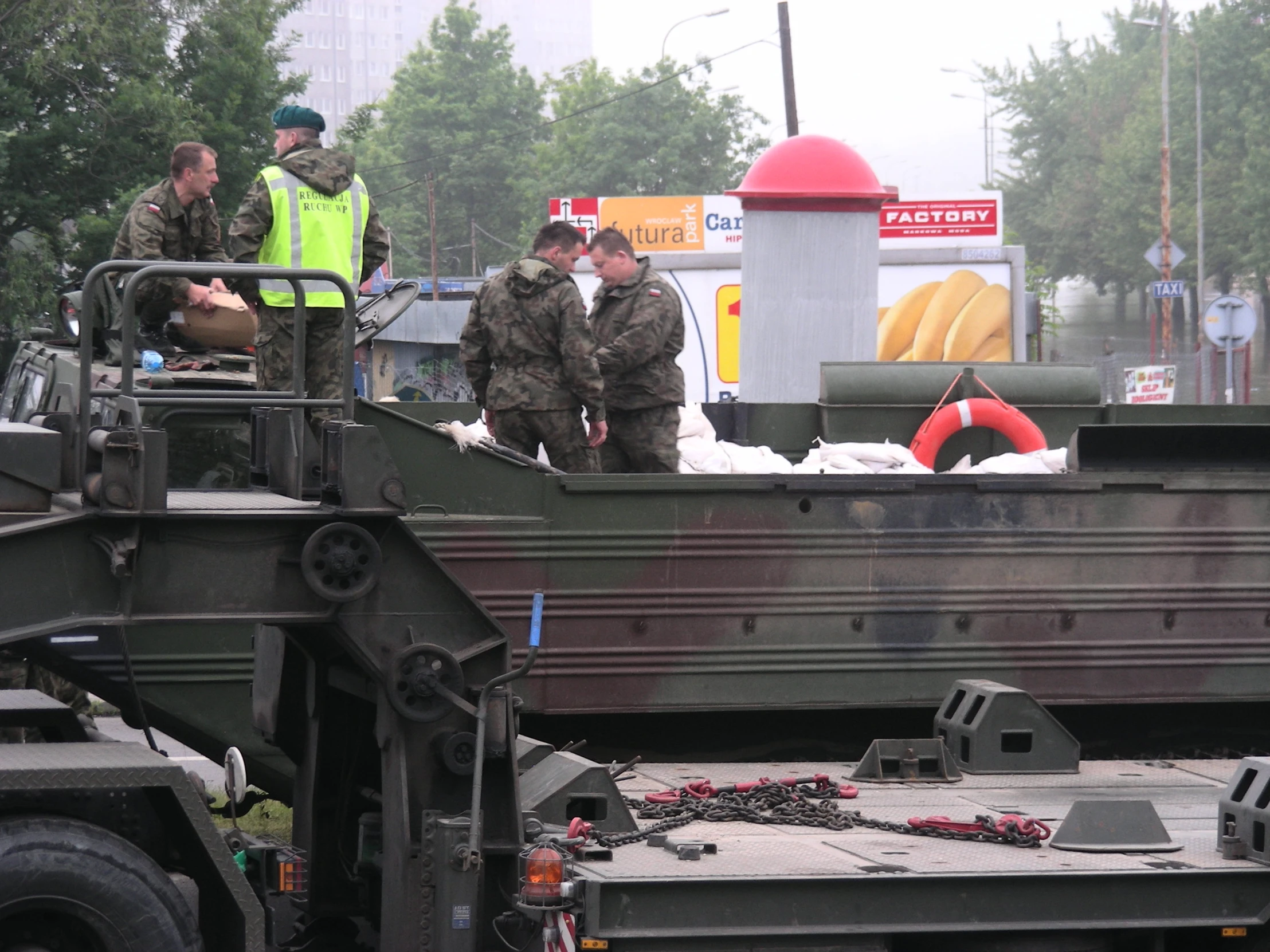 soldiers on the top of a green truck