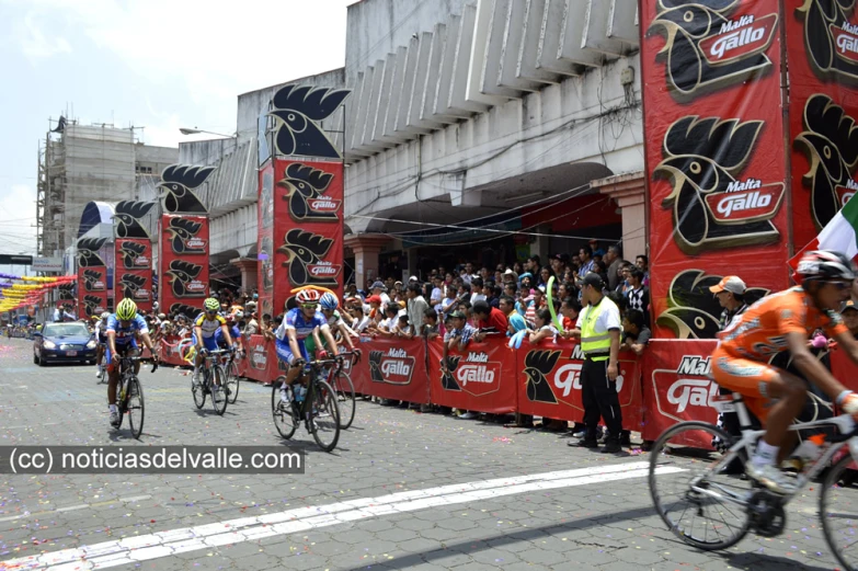 the men are riding their bikes in a race