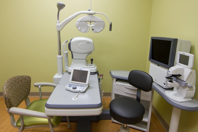 a computer and laptop placed on a medical desk