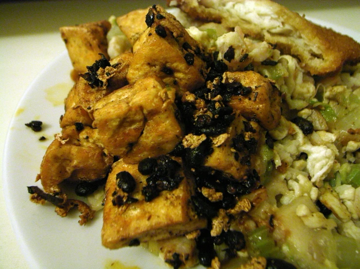 a white plate topped with fried food and salad