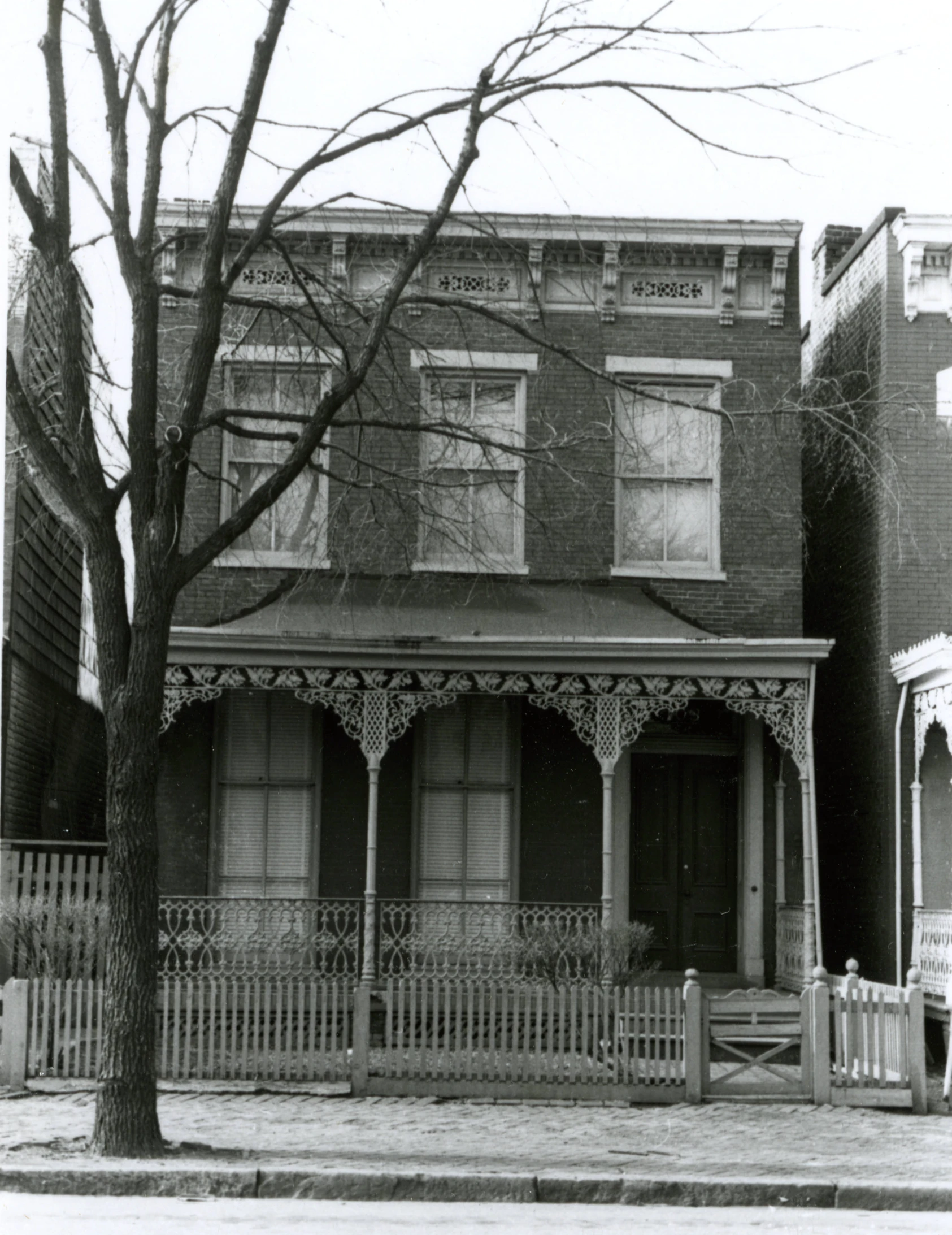 the building has a large porch and columns