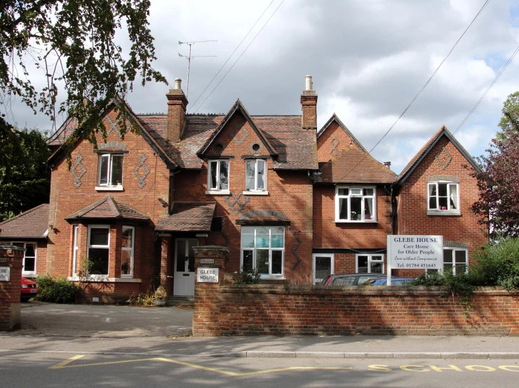 large red brick house with chimneys and windows