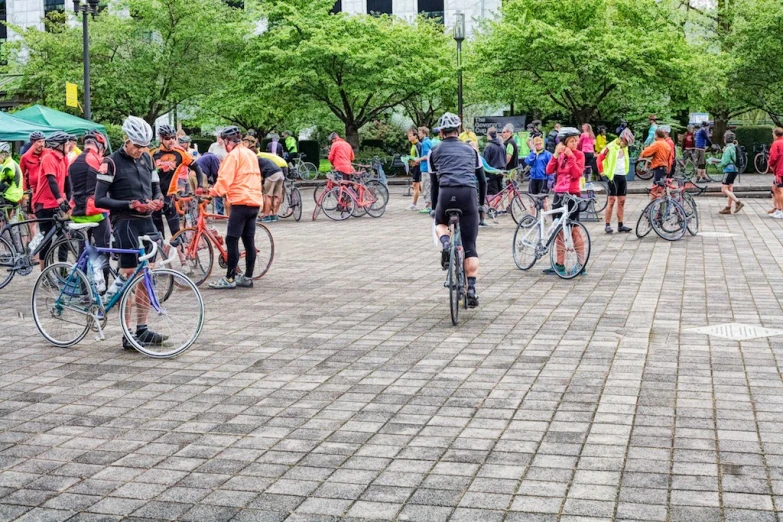 a number of people on bicycles in a parking lot