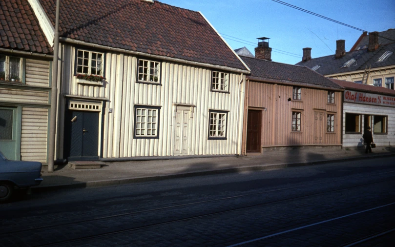 a man walking down the street in front of buildings