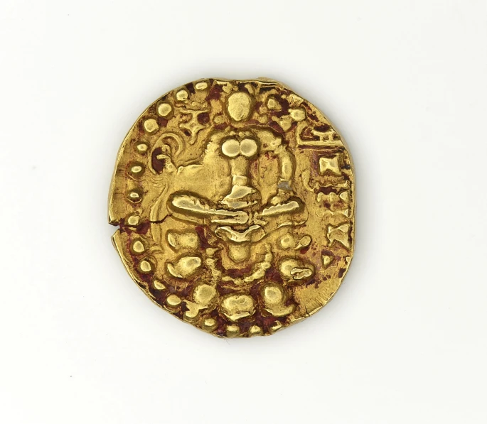 a round gold object with different designs and colors on it