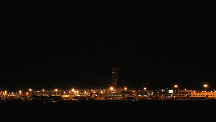 a large field in front of a city at night