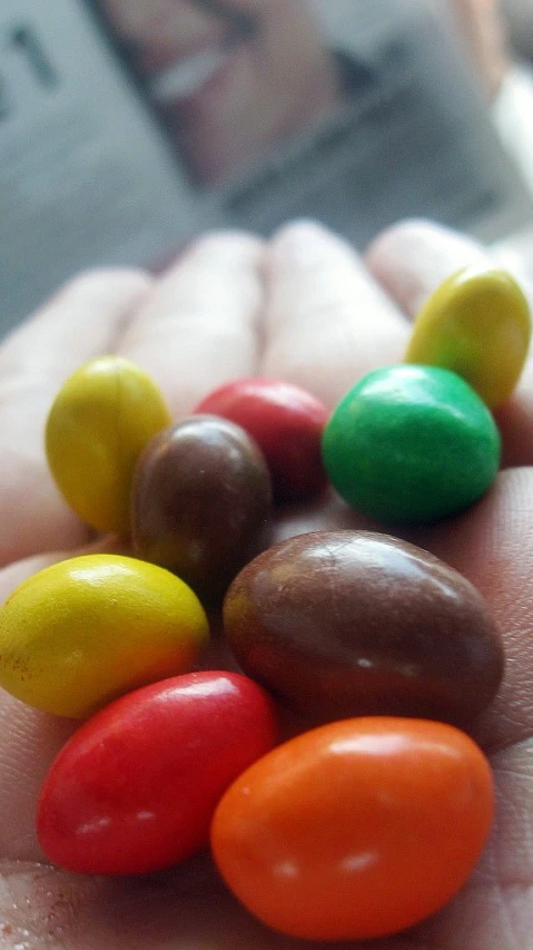 this little candy is in the palm of someones hand