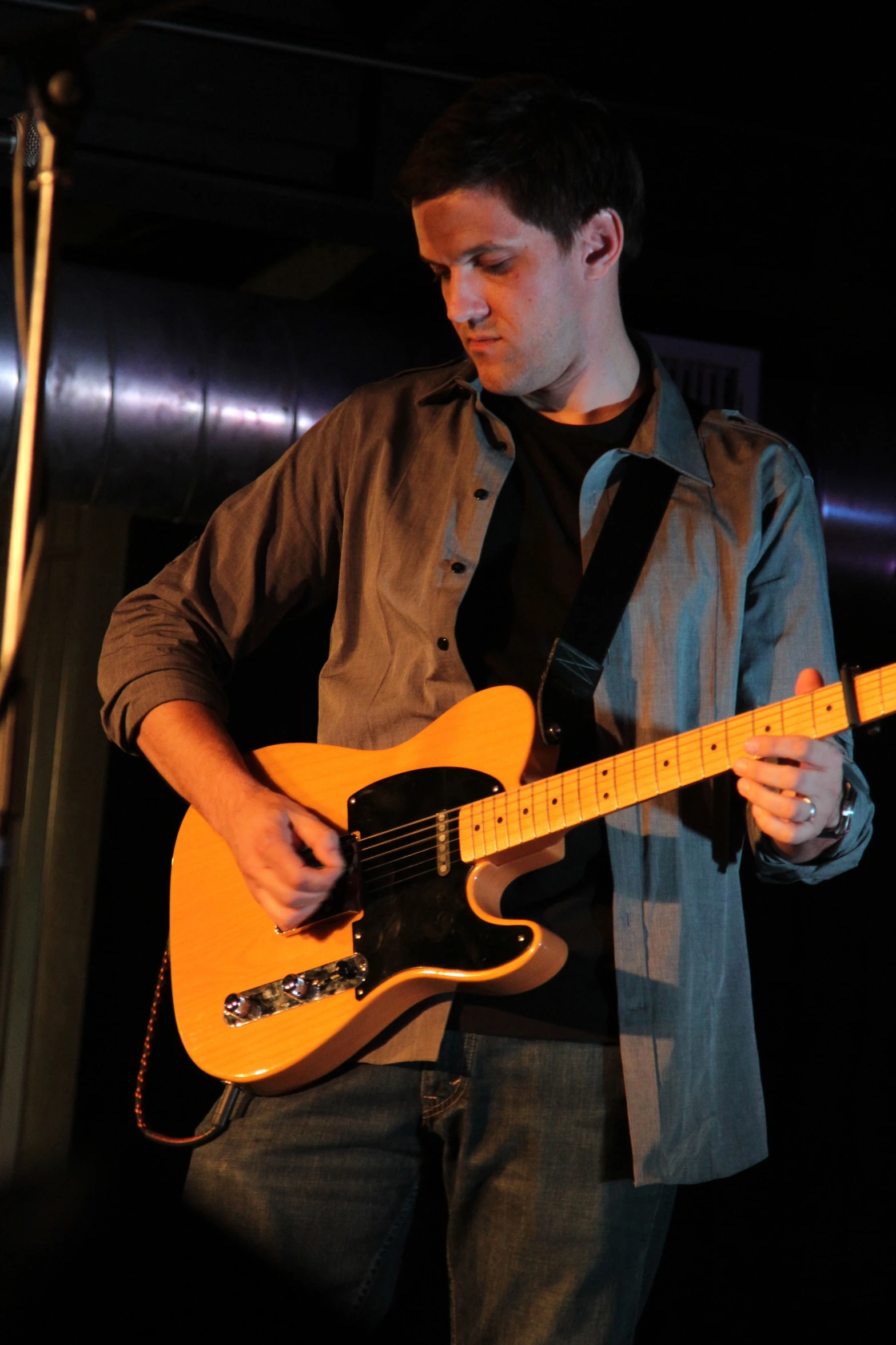 a man playing an electric guitar at a concert