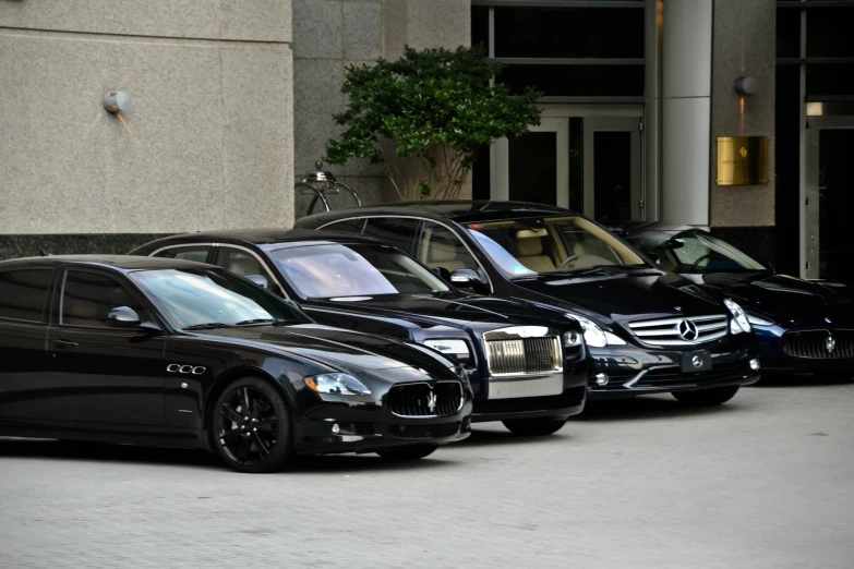 there are black and silver cars parked side by side