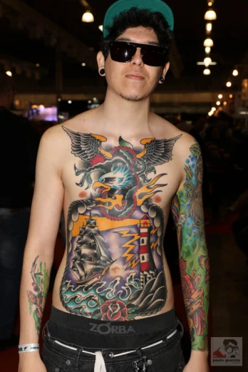 a person with tattoos is wearing a hat and shades
