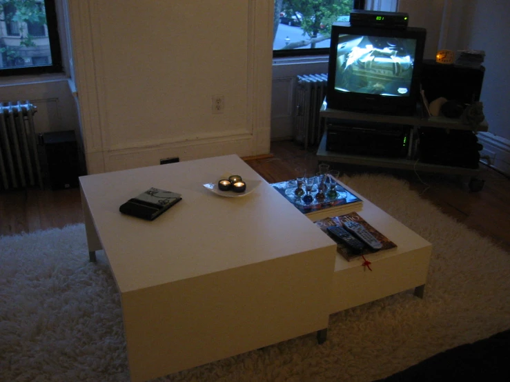 living room with flat screen tv on coffee table