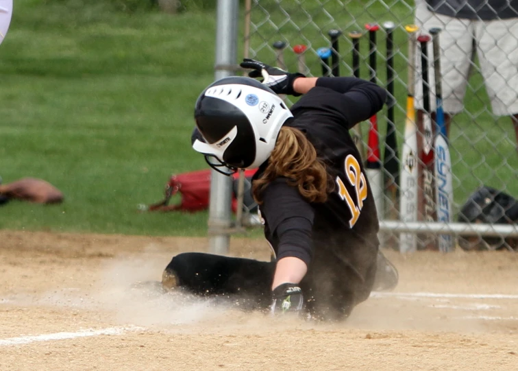 the female player has fallen down from catching the ball