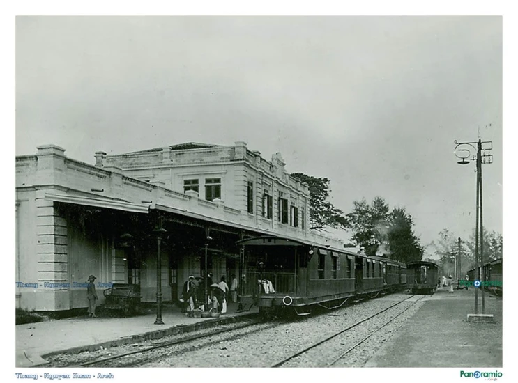 an old fashioned train stopped at a station