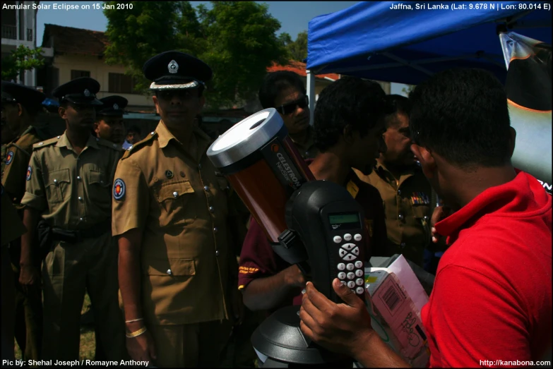 an officer talks to a man with a drum