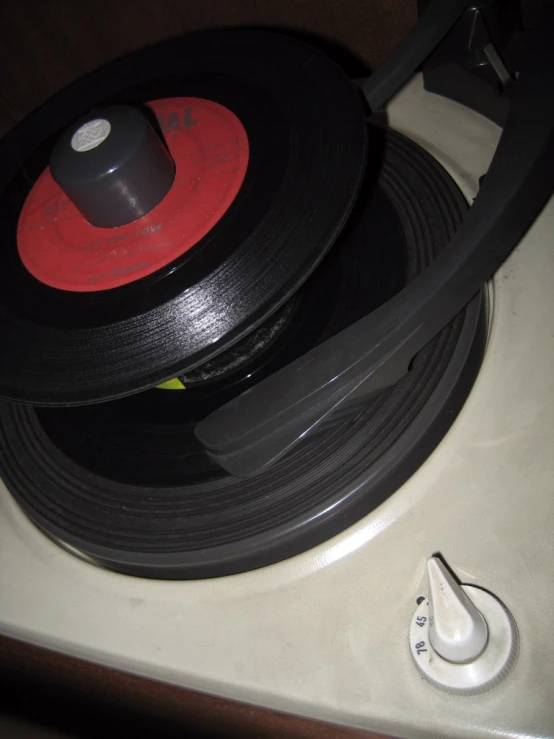 close up of an old vintage record player with the red disk on top