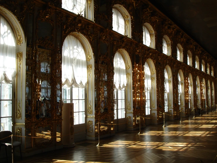 the sun shining through windows casts a reflection in a palace