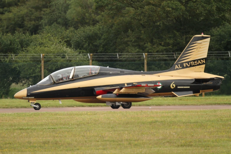 a jet sitting on top of an airport runway