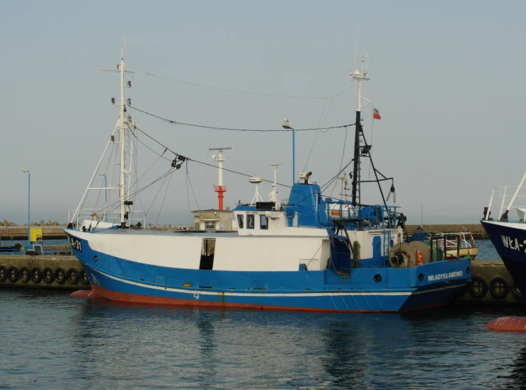 two boats sitting on water next to each other