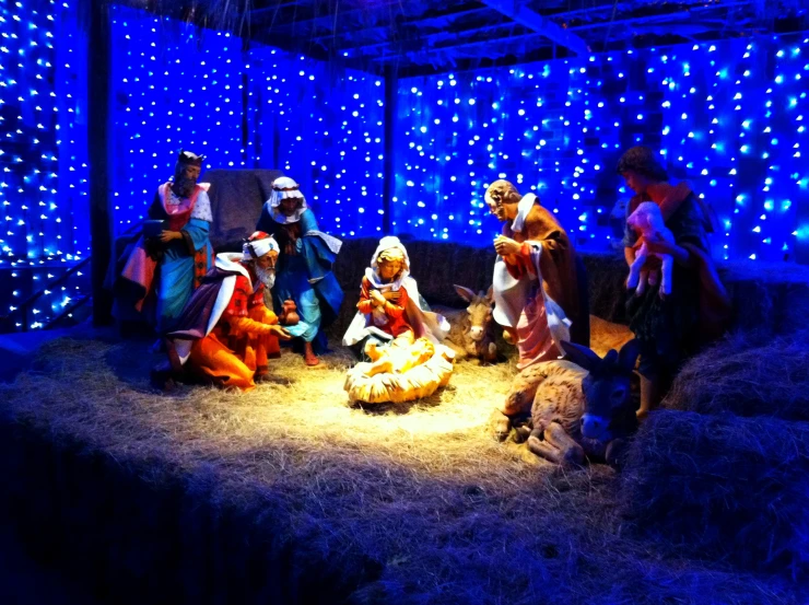 an indoor nativity scene with several people in robes