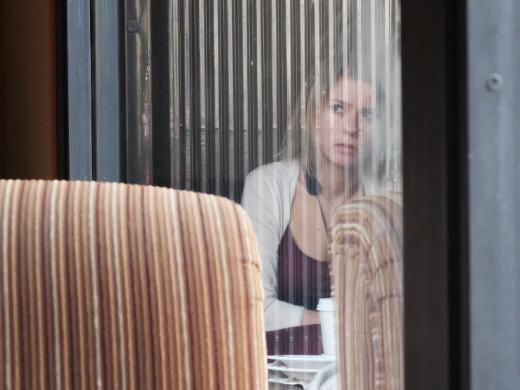 the woman sits alone on the outside terrace