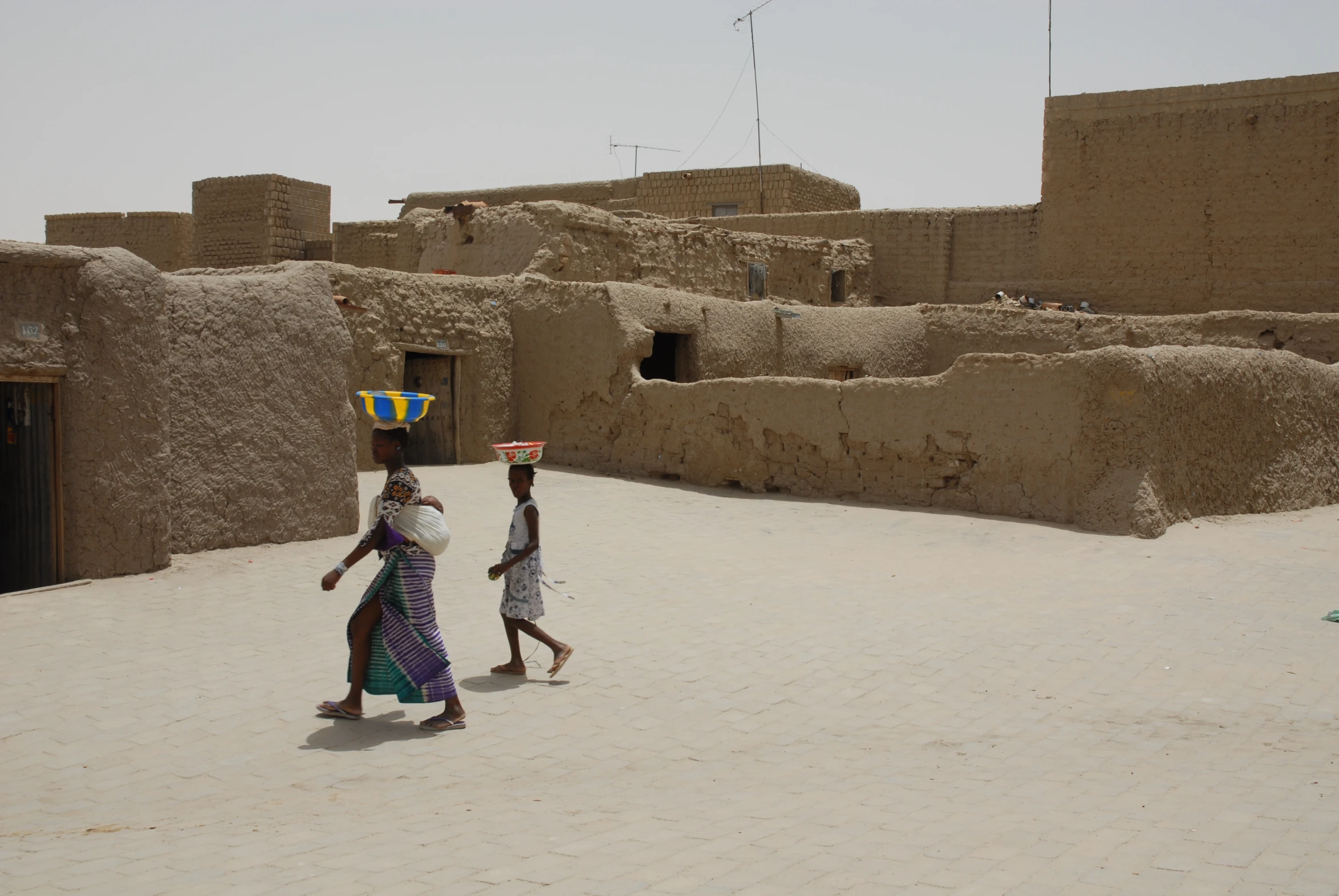 a couple of people are walking together on a road