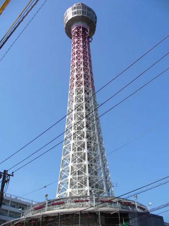 there is a large white and pink tower on top of a building