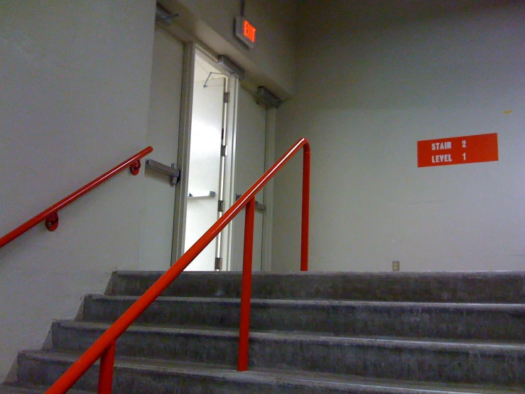 the entrance to the elevator has red steps that lead up to it