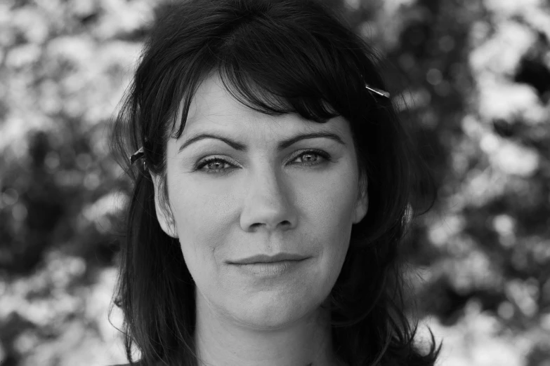 a woman with dark hair smiling into the camera