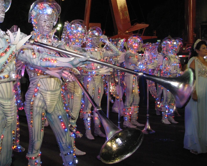 a large group of white performers are lined up with musical instruments