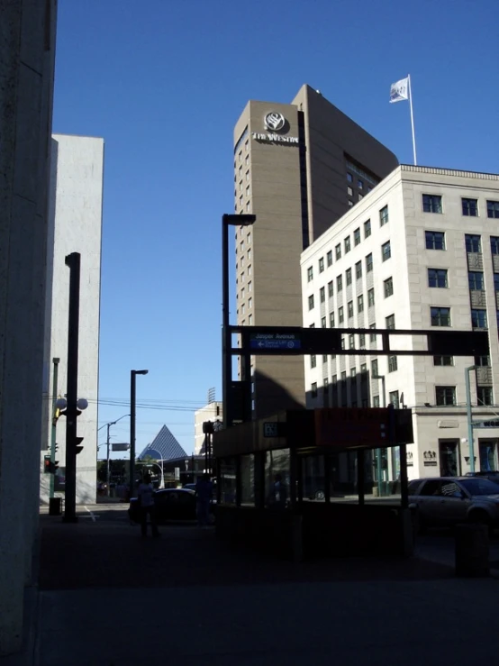 a traffic light hanging over a street near a tall building