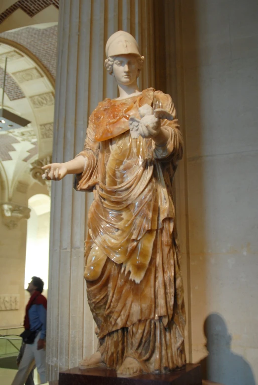 a statue of a woman with an orange dress