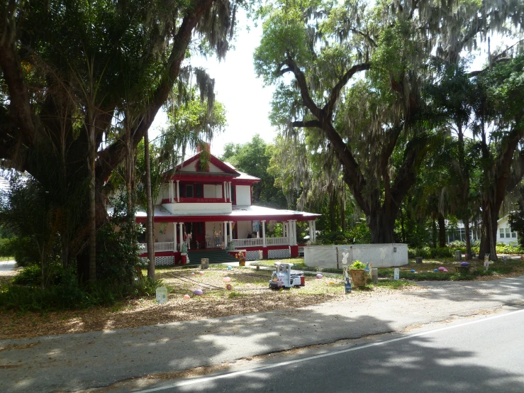 a street view of an old, red and white house