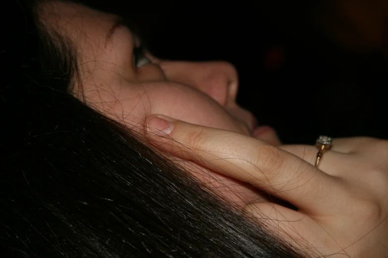 a woman using a phone in a dark room