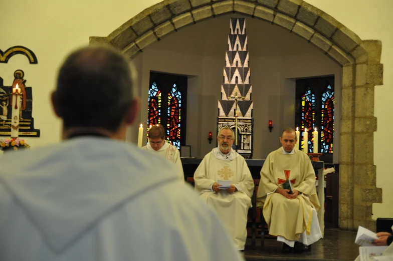 priests are sitting together and the priest is reading