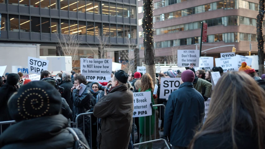 people holding signs protesting against the government