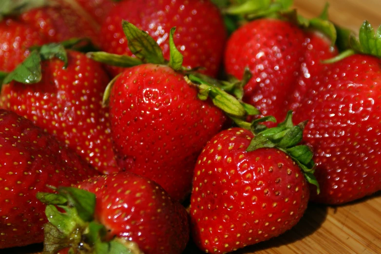 many strawberries are piled up on the table