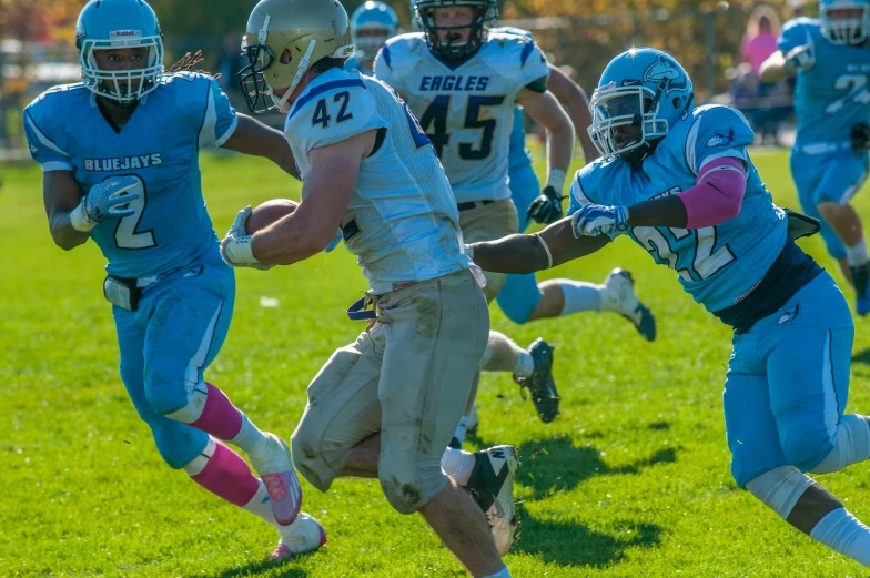 a football team running after the ball during a game