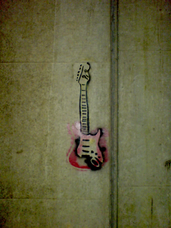 an electric guitar, with graffiti on the side