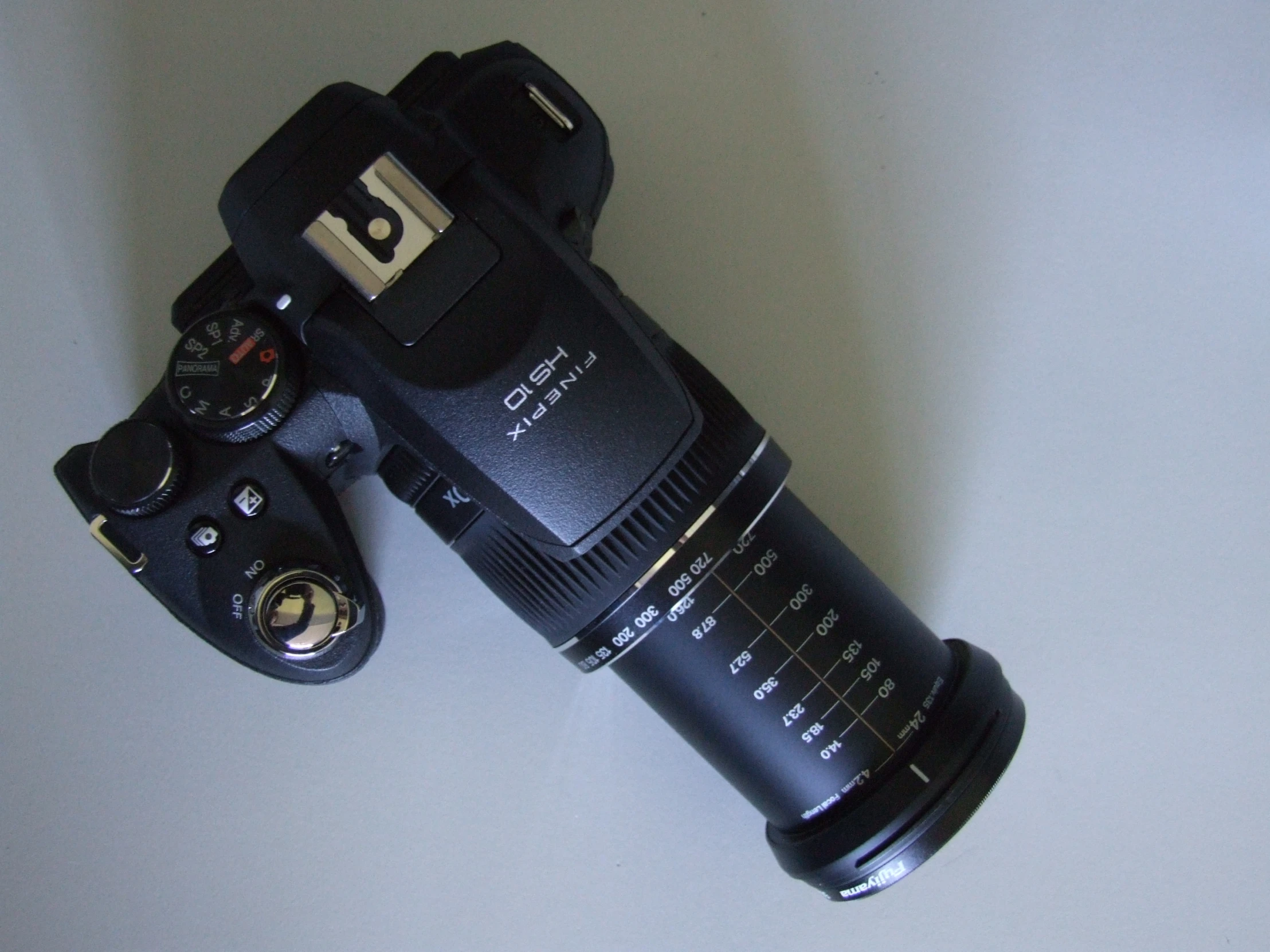 a black camera on a table with focus light in front