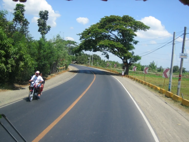 a person riding a motorcycle on a road