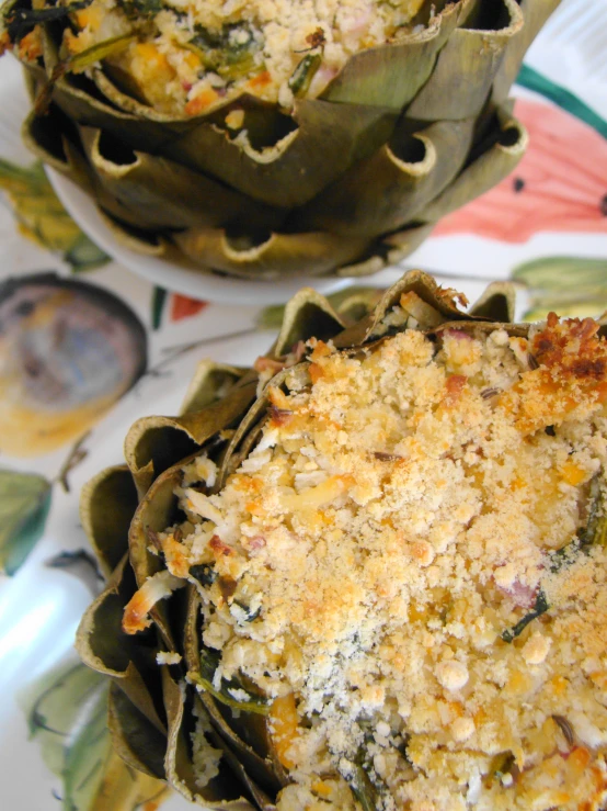 a large muffin next to another muffin in a flower print plate