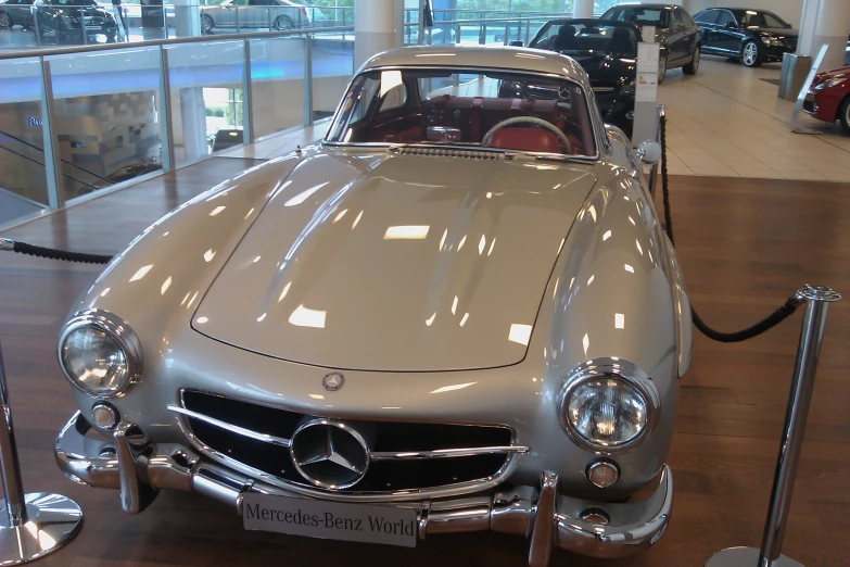 a mercedes benz sports car parked in a showroom