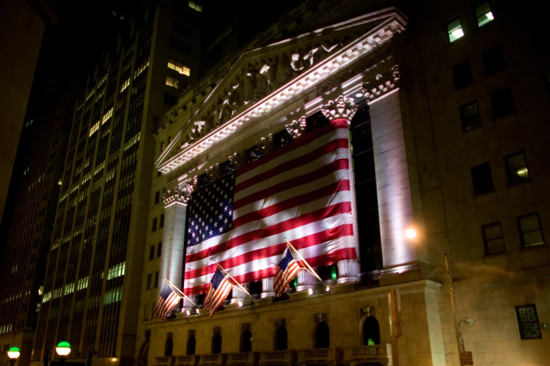 a tall building covered in lights and american flags