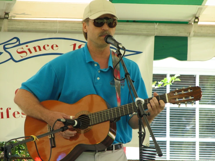 the man is playing the guitar while singing