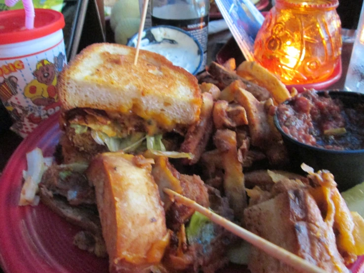 the plate with the sandwiches is piled on top of other plates