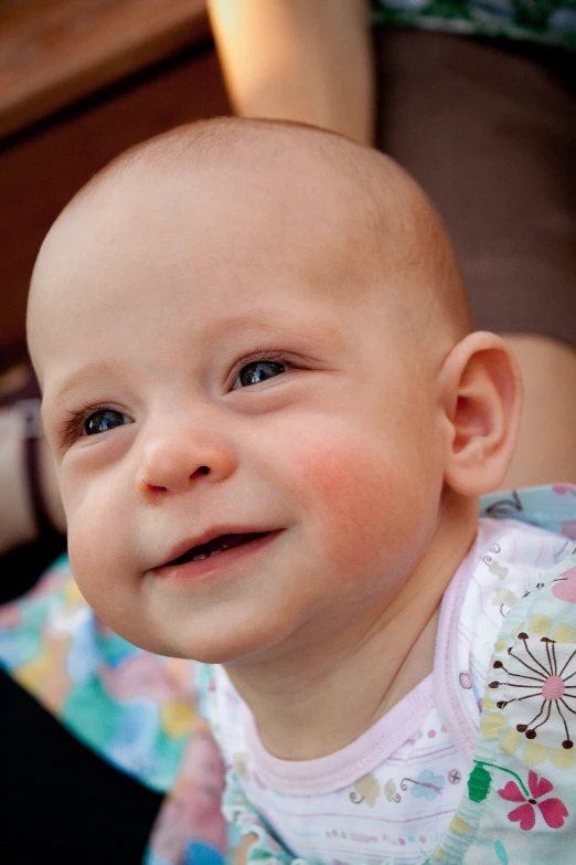 a baby looking at the camera while smiling